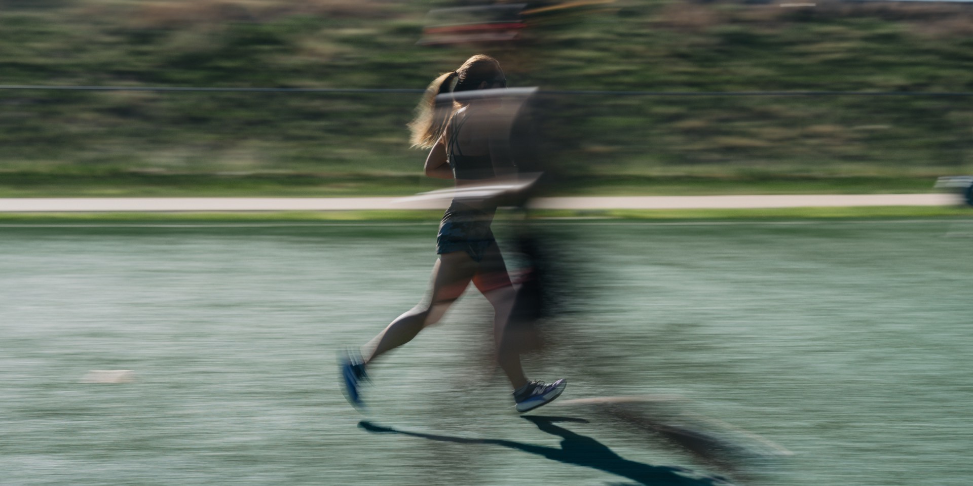 Runner moving fast across an outdoor track